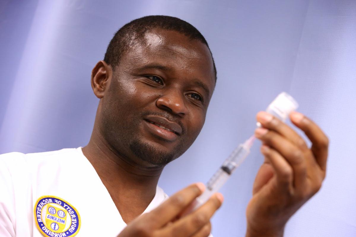 University of Rochester employee uses a syringe