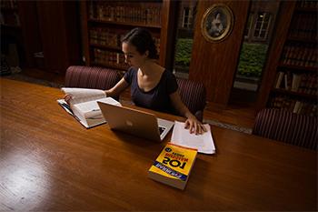 A student works in the Seward Room of Rush Rhees Library.