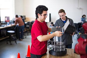 Electrical engineering students working on a project