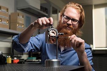 An optical engineering student working on a project