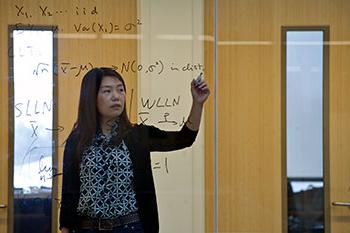 A student working on statistics computations