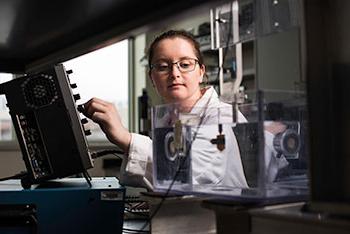 Graduate student working in a lab.